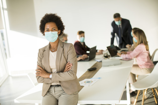 African American woman in the office wear mask as protection from corona virus